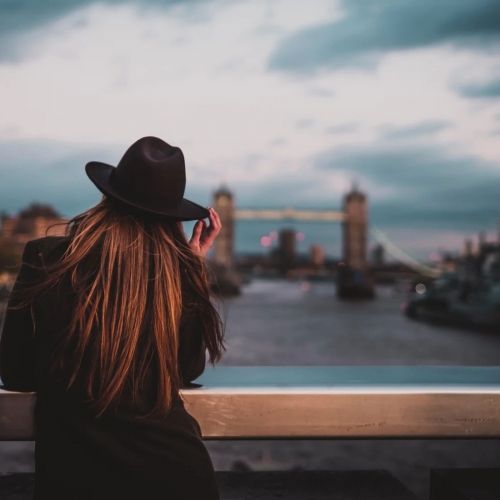 Student looking out over the Thames at London Bridge